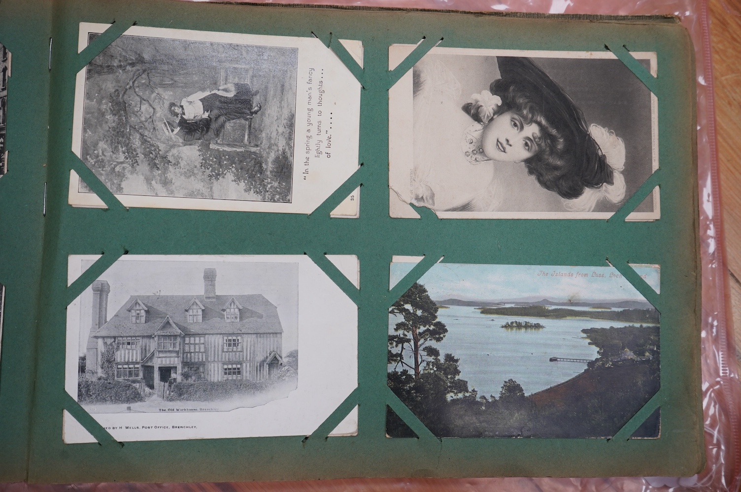 A postcard album with various postcards. Condition - damp damage